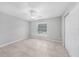 Inviting bedroom with tile flooring, a ceiling fan, and natural light at 12112 Helios Ave, Port Charlotte, FL 33981