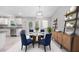 Tastefully decorated dining area adjacent to the kitchen, illuminated by modern lighting fixtures at 12112 Helios Ave, Port Charlotte, FL 33981