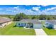 Charming single-story home with a well-manicured lawn and attached two-car garage at 12112 Helios Ave, Port Charlotte, FL 33981