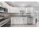 Modern kitchen featuring stainless steel appliances, granite countertops, and ample cabinet space at 12112 Helios Ave, Port Charlotte, FL 33981
