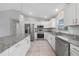 Well-lit kitchen showcasing granite counters, stainless appliances, and white cabinetry for a clean, modern look at 12112 Helios Ave, Port Charlotte, FL 33981