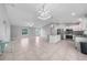 Spacious kitchen featuring white cabinets, stainless steel appliances, and a large island with granite countertops at 12112 Helios Ave, Port Charlotte, FL 33981