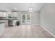 Bright kitchen area adjacent to outdoor access features a stainless steel dishwasher at 12112 Helios Ave, Port Charlotte, FL 33981