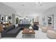 Spacious open-concept living area with modern decor and plenty of natural light, with kitchen in the background at 12112 Helios Ave, Port Charlotte, FL 33981