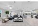 Bright living room boasts an open layout, connecting seamlessly to the kitchen with a breakfast bar at 12112 Helios Ave, Port Charlotte, FL 33981