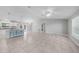 Bright and airy room has tile flooring, seamlessly connecting to the kitchen and outdoor spaces at 12112 Helios Ave, Port Charlotte, FL 33981