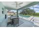 Covered patio with a dining table and a view of the pool and yard at 12112 Helios Ave, Port Charlotte, FL 33981