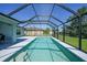 Lovely screened-in pool featuring steps into the water and a spacious patio for lounging at 12112 Helios Ave, Port Charlotte, FL 33981