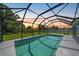 Inviting screened-in pool perfect for evening relaxation and enjoying the sunset at 12112 Helios Ave, Port Charlotte, FL 33981