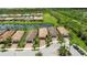 An aerial view of the neighborhood houses with brown roofs and palm trees surrounded by lush green lawns at 13935 Campoleone St, Venice, FL 34293