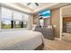 Comfortable bedroom with a dresser, large window with backyard view, and a ceiling fan at 13935 Campoleone St, Venice, FL 34293