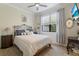 Serene bedroom with a wrought iron bed frame, soft colors, and natural light for a peaceful retreat at 13935 Campoleone St, Venice, FL 34293