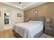 Relaxing bedroom featuring a king-size bed, wood floors and a view of the walk-in closet at 13935 Campoleone St, Venice, FL 34293