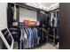 Well-organized walk-in closet with dark wood shelving, providing ample storage space and style at 13935 Campoleone St, Venice, FL 34293