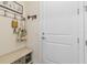 Welcoming entryway with bench seating, hooks, and coat rack, providing functionality and style at 13935 Campoleone St, Venice, FL 34293