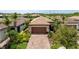 Well-maintained single Gathering home with tile roof and brick driveway surrounded by palm trees at 13935 Campoleone St, Venice, FL 34293