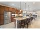 Inviting kitchen features stainless appliances, a granite island, and a breakfast bar with seating at 13935 Campoleone St, Venice, FL 34293
