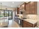 Bright kitchen featuring stainless steel appliances, granite countertops and decorative backsplash at 13935 Campoleone St, Venice, FL 34293