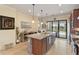 Well lit kitchen boasting granite countertops, stainless steel appliances and backyard view at 13935 Campoleone St, Venice, FL 34293