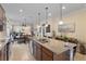 Spacious open kitchen with a granite island, stainless steel appliances and tile flooring at 13935 Campoleone St, Venice, FL 34293