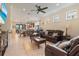 Open-concept living room with tile floors, comfortable seating, and an adjacent dining area at 13935 Campoleone St, Venice, FL 34293