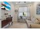 Inviting living room with comfortable seating, decorative accents, and a mounted television for relaxation at 13935 Campoleone St, Venice, FL 34293