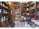 Walk-in pantry with custom wood shelving for wine, spices, and cookware at 13935 Campoleone St, Venice, FL 34293