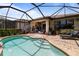 Sparkling pool with screened enclosure, brick pavers, and an outdoor lounge area at 13935 Campoleone St, Venice, FL 34293