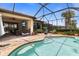 A beautiful screened-in pool area with a brick patio, outdoor seating, and clear blue skies above the community at 13935 Campoleone St, Venice, FL 34293