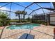 A beautiful screened-in pool area with a brick patio, palm trees, and clear blue skies above the community at 13935 Campoleone St, Venice, FL 34293