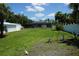 Expansive backyard featuring a screened-in pool area, white fence, and mature landscaping at 15037 Mcgraw Ave, Port Charlotte, FL 33953