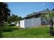 Large backyard features a white privacy fence and beautiful mature trees at 15037 Mcgraw Ave, Port Charlotte, FL 33953