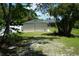 Metal backyard shed surrounded by trees, offering practical storage solutions and blending with nature at 15037 Mcgraw Ave, Port Charlotte, FL 33953