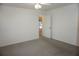 Bedroom with neutral carpet, ceiling fan, and backyard access at 15037 Mcgraw Ave, Port Charlotte, FL 33953