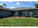 Charming home featuring a landscaped front yard with a fountain and artistic statue detail at 15037 Mcgraw Ave, Port Charlotte, FL 33953