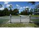 Gated entrance view, enhancing privacy and security of the property with a white picket fence at 15037 Mcgraw Ave, Port Charlotte, FL 33953