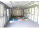 Spacious shed interior with metal walls, a concrete floor, and colorful mats, ready for storage or hobbies at 15037 Mcgraw Ave, Port Charlotte, FL 33953