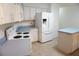 Full kitchen view featuring an island, stainless steel appliances, and ample cabinet space at 15037 Mcgraw Ave, Port Charlotte, FL 33953