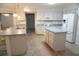 This spacious kitchen has a center island, white cabinetry, and modern appliances at 15037 Mcgraw Ave, Port Charlotte, FL 33953