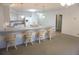 Open-concept kitchen features a breakfast bar, white cabinets, and ample counter space for cooking at 15037 Mcgraw Ave, Port Charlotte, FL 33953