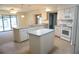 Bright kitchen features white cabinets, an island, modern appliances, and plenty of counter space at 15037 Mcgraw Ave, Port Charlotte, FL 33953