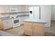 Bright kitchen with island, white appliances, and plenty of cabinet space at 15037 Mcgraw Ave, Port Charlotte, FL 33953