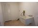 Practical laundry room with a utility sink, closet, and tiled floor at 15037 Mcgraw Ave, Port Charlotte, FL 33953