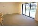 Bright living room features sliding glass doors with a view of the pool at 15037 Mcgraw Ave, Port Charlotte, FL 33953