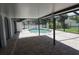 A screened in pool deck shows a well designed brick patio and lovely pool view at 15037 Mcgraw Ave, Port Charlotte, FL 33953
