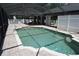 Sparkling in-ground pool with a screened enclosure, brick paver deck, and white fencing at 15037 Mcgraw Ave, Port Charlotte, FL 33953