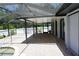 Enclosed pool deck featuring brick pavers, a partial view of the pool, and white privacy fencing at 15037 Mcgraw Ave, Port Charlotte, FL 33953