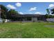 Lush backyard featuring a screened pool, offering a blend of leisure and privacy at 15037 Mcgraw Ave, Port Charlotte, FL 33953