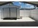 Exterior view of a metal shed, white privacy fence and concrete pad at 15037 Mcgraw Ave, Port Charlotte, FL 33953