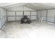 Inside of a metal building featuring a tractor and plenty of storage space at 15037 Mcgraw Ave, Port Charlotte, FL 33953